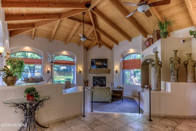 living room with beamed ceiling, wood ceiling, and ceiling fan