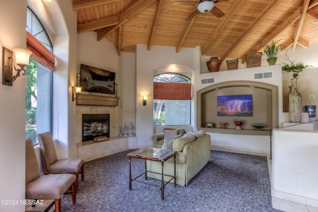 living room featuring a healthy amount of sunlight, beamed ceiling, and wooden ceiling