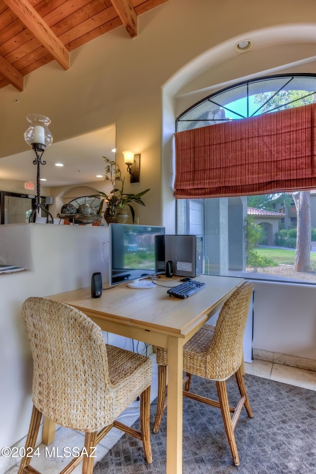 dining space featuring beam ceiling, wooden ceiling, and tile patterned floors