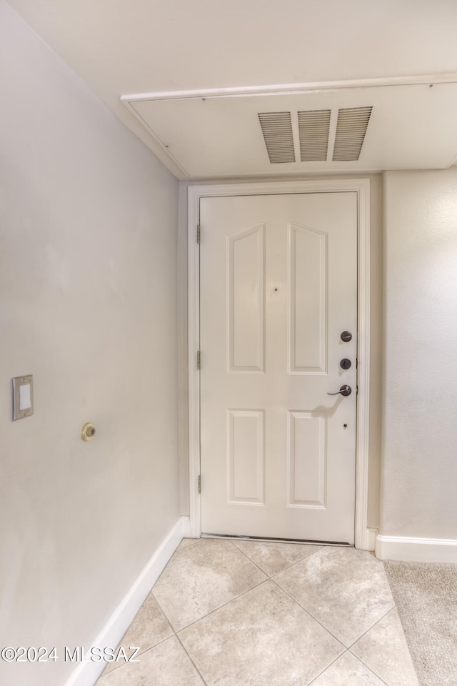 doorway with light tile patterned floors