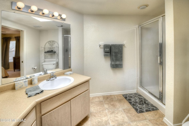 bathroom with vanity, toilet, and a shower with shower door