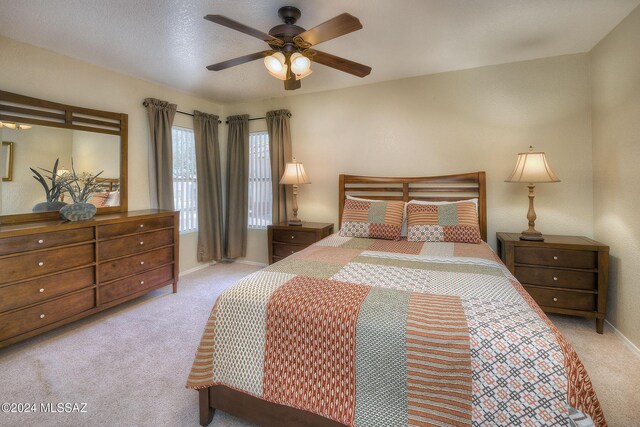 bedroom featuring light colored carpet and ceiling fan