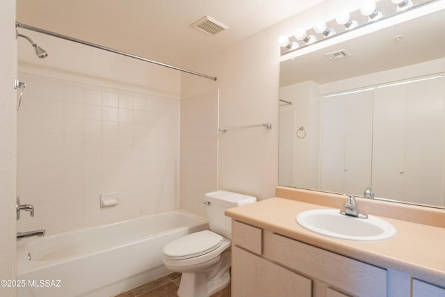 bathroom featuring visible vents, shower / tub combination, vanity, tile patterned floors, and toilet
