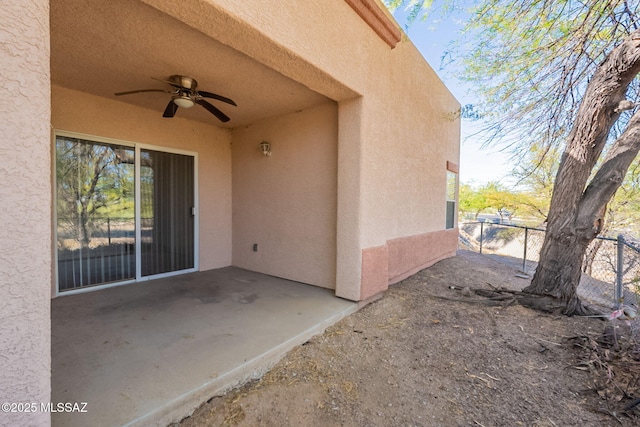 view of patio / terrace featuring ceiling fan and fence