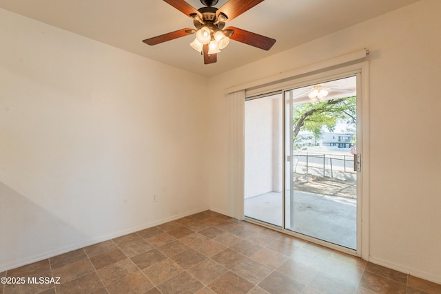 unfurnished room with a ceiling fan and baseboards