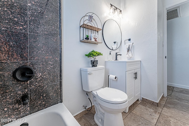 bathroom featuring tile patterned floors, vanity, toilet, and a tub