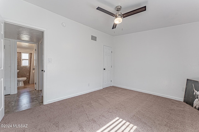 carpeted empty room featuring ceiling fan