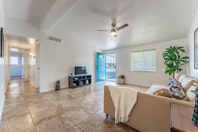 living room with ceiling fan and a healthy amount of sunlight