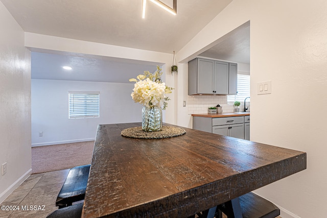 carpeted dining room featuring sink