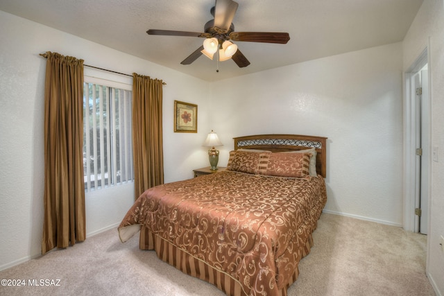 bedroom featuring ceiling fan and light colored carpet