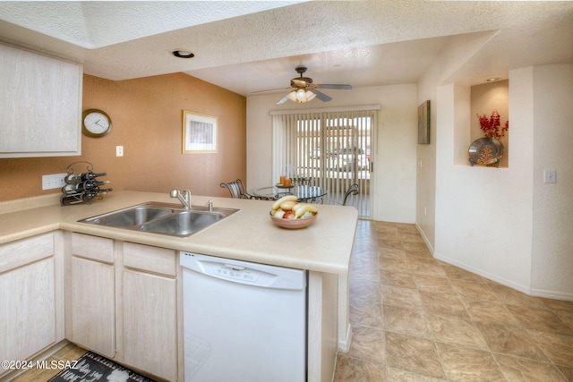 kitchen with ceiling fan, sink, kitchen peninsula, white dishwasher, and a textured ceiling