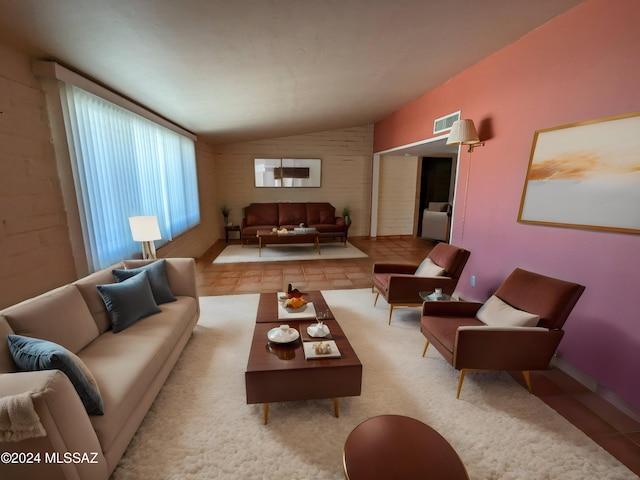 living room featuring vaulted ceiling and light tile patterned floors