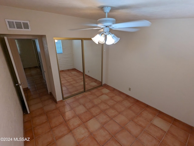 unfurnished bedroom featuring light tile patterned floors, ceiling fan, and a closet