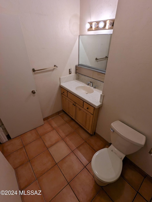 bathroom with vanity, tile patterned floors, and toilet