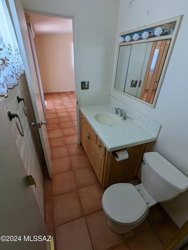 bathroom with vanity, tile patterned flooring, and toilet