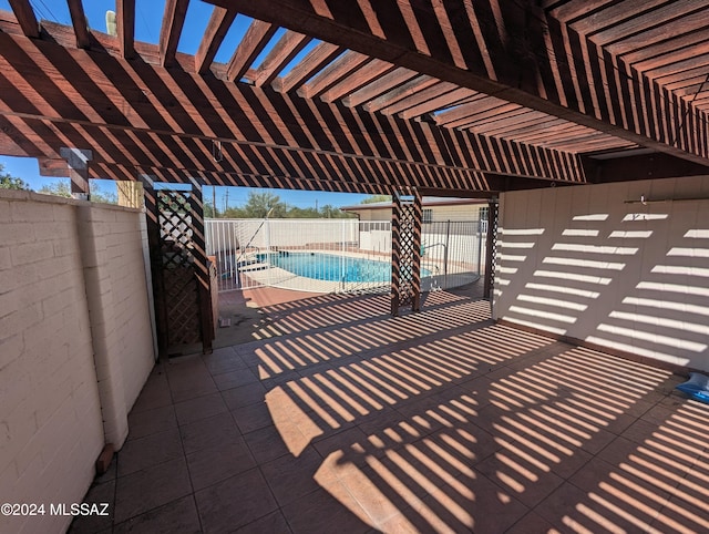 view of patio featuring a fenced in pool and a pergola