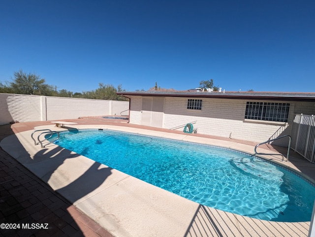 view of swimming pool featuring a patio area