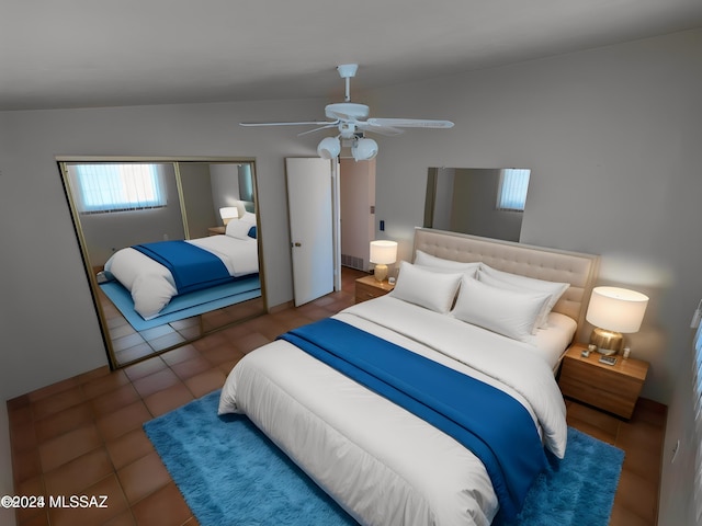 tiled bedroom featuring ceiling fan