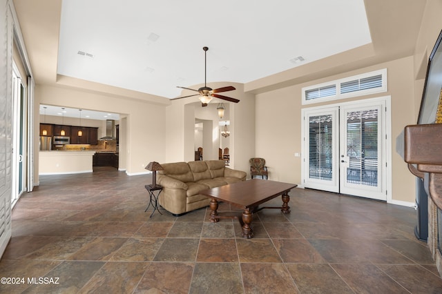 living room featuring ceiling fan and french doors