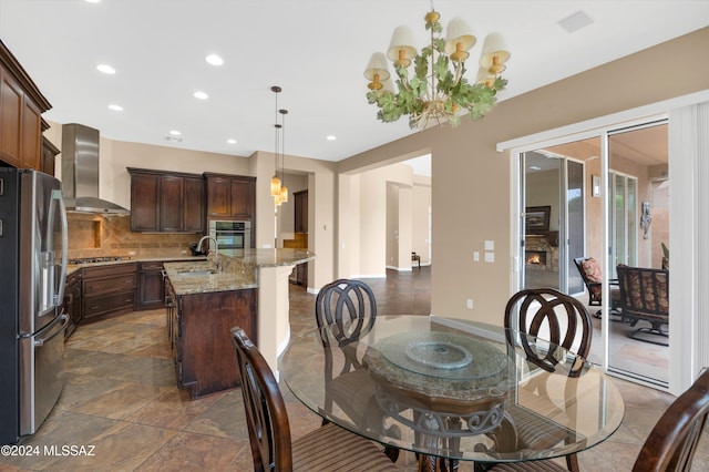 dining area featuring sink and a notable chandelier