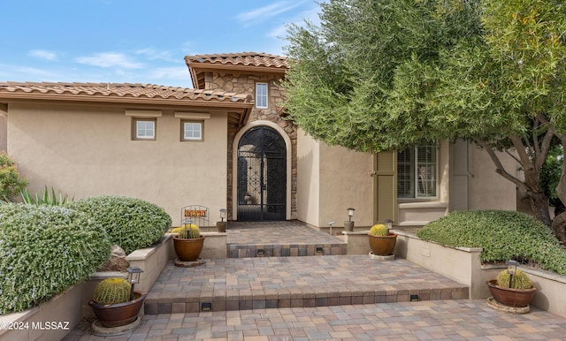 property entrance featuring a patio area