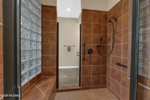 bathroom with tiled shower and tile patterned floors