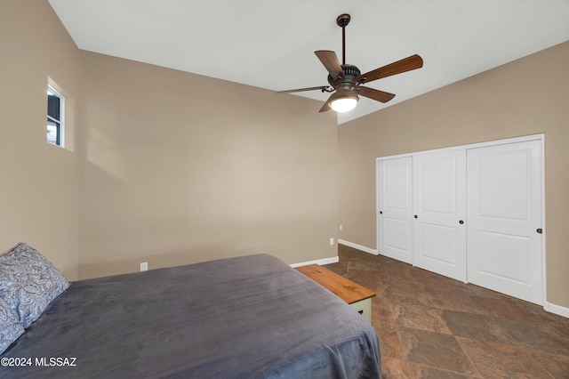 bedroom with ceiling fan, a closet, and vaulted ceiling