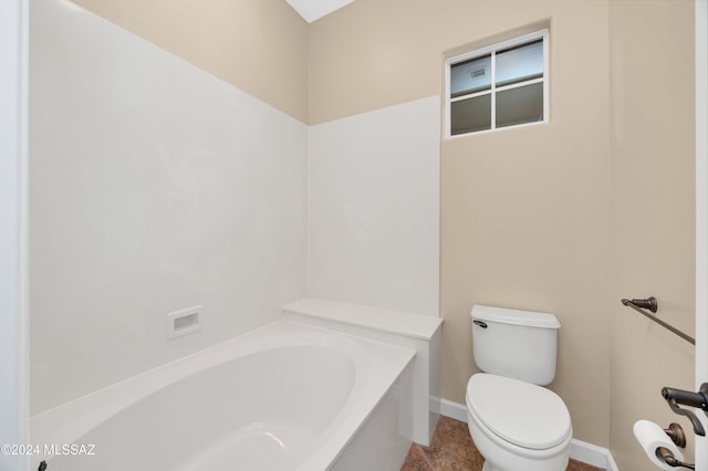 bathroom featuring a bathing tub, tile patterned flooring, and toilet