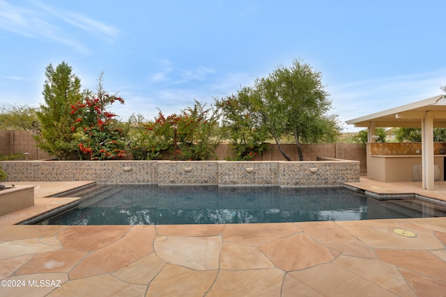 view of swimming pool featuring area for grilling and a patio