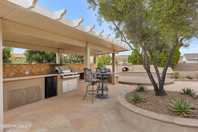 view of patio featuring grilling area and exterior kitchen