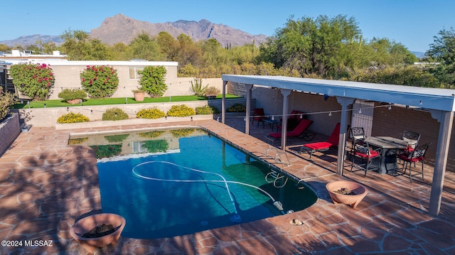 view of swimming pool featuring a mountain view and a patio area