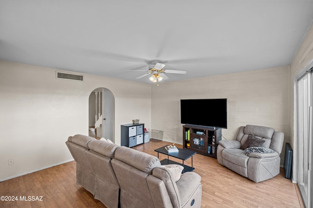 living room featuring ceiling fan and light wood-type flooring