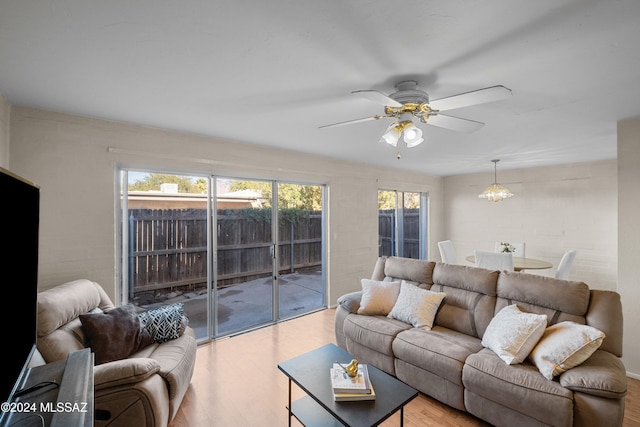 living room featuring hardwood / wood-style floors and ceiling fan