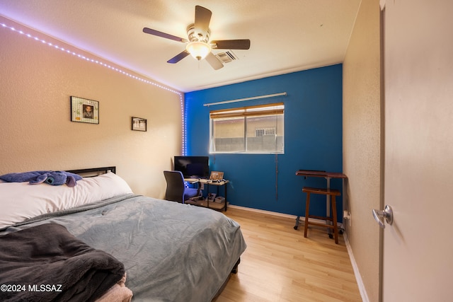 bedroom with ceiling fan and light hardwood / wood-style flooring