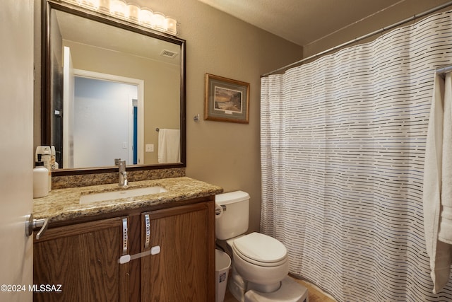 bathroom with walk in shower, vanity, a textured ceiling, and toilet