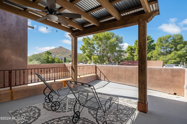 view of patio / terrace with a mountain view and ceiling fan