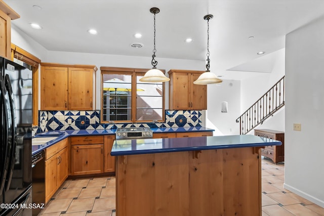 kitchen featuring black appliances, hanging light fixtures, and decorative backsplash