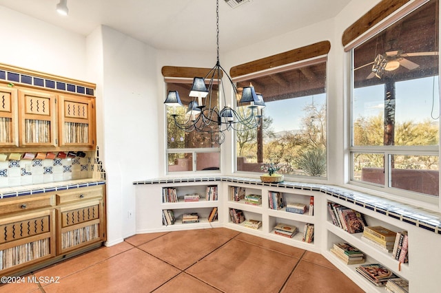 interior space featuring visible vents, a chandelier, and light tile patterned flooring