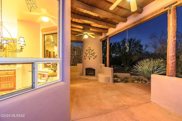 view of patio / terrace featuring a ceiling fan and an outdoor fireplace