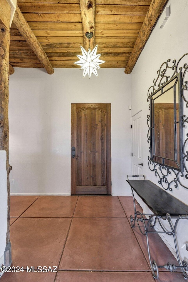 corridor with concrete floors, wooden ceiling, and beamed ceiling