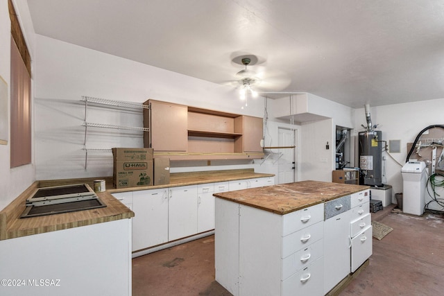 kitchen with unfinished concrete floors, white cabinetry, open shelves, and gas water heater