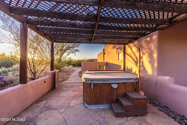 view of patio / terrace with a hot tub and a pergola