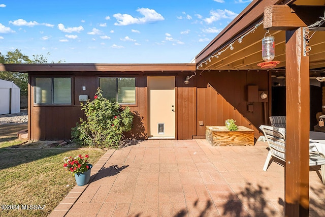 exterior space with a patio, a storage shed, and a yard