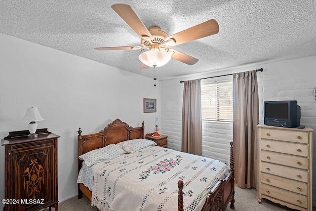 bedroom with ceiling fan, a textured ceiling, and light colored carpet