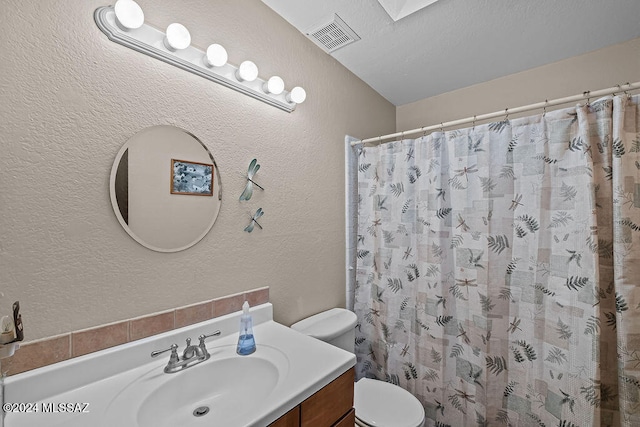 bathroom featuring vanity, toilet, and a shower with curtain