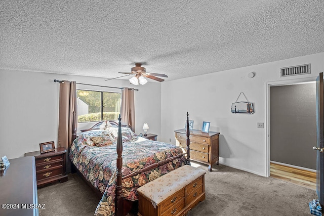 carpeted bedroom with a textured ceiling and ceiling fan