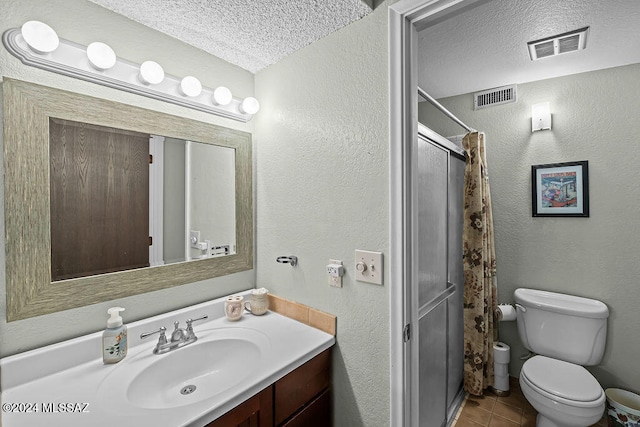 bathroom with toilet, a textured ceiling, walk in shower, and vanity