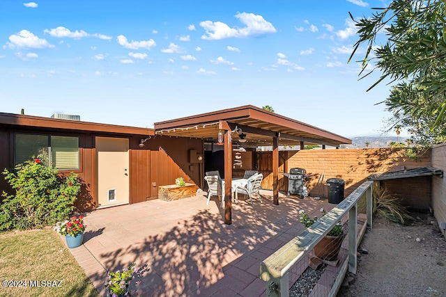 view of patio with a grill and ceiling fan