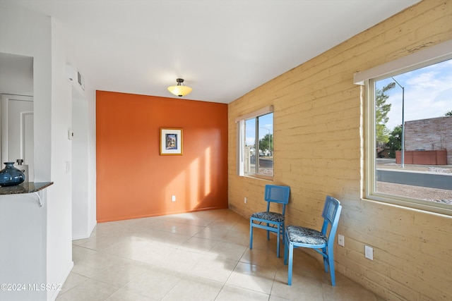 living area featuring brick wall