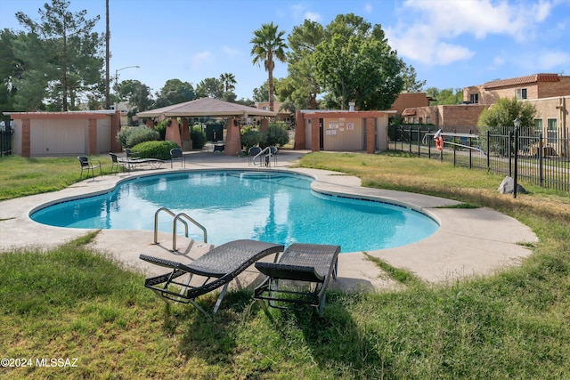 view of pool with a shed, a patio area, and a yard